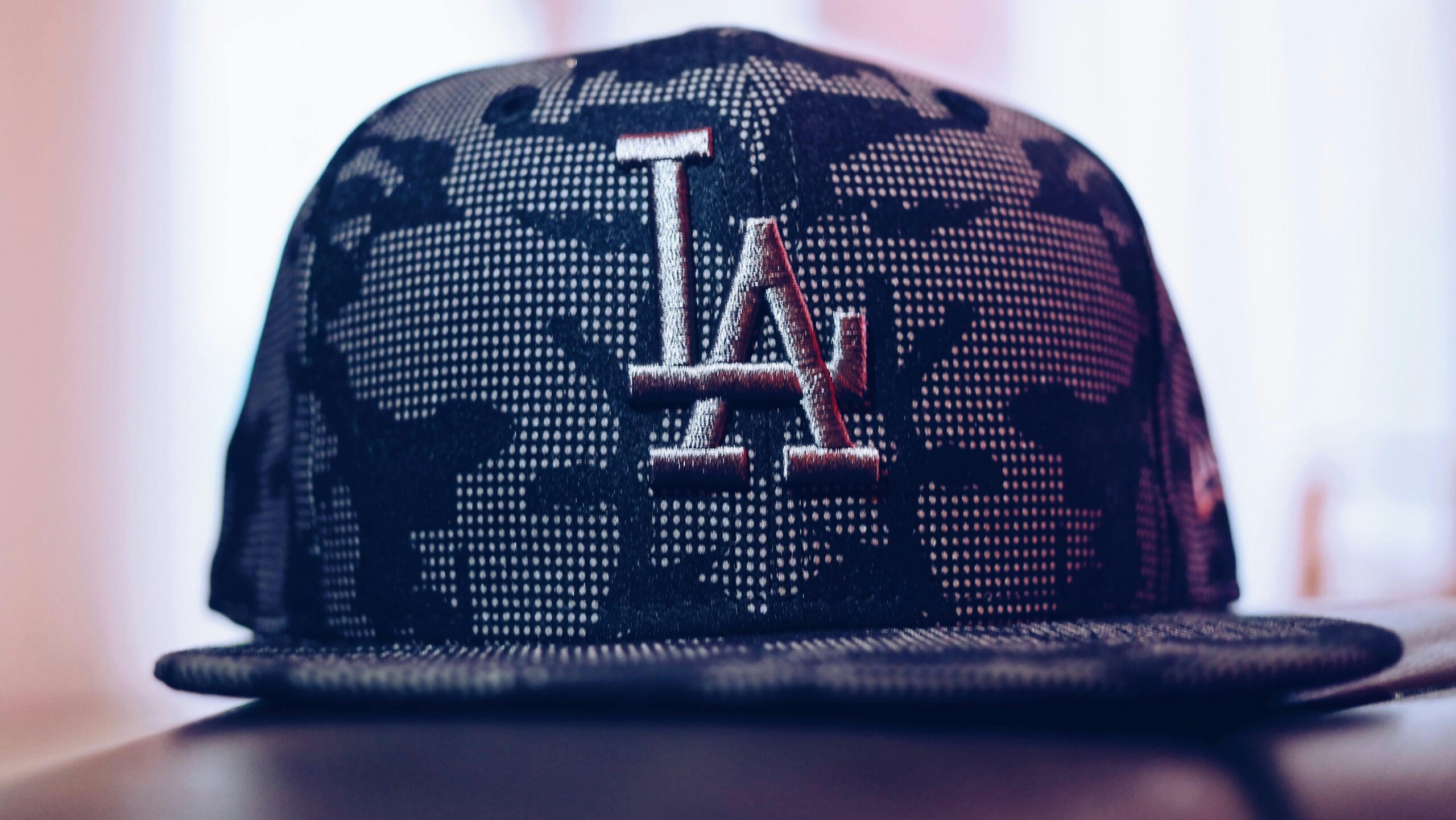 Close-up of a trendy Los Angeles baseball cap with a modern design indoors.